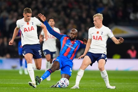 Crystal Palace's Mateta stretches for the ball between two Tottenham defenders in white and fouls Mickey van de Ven.
