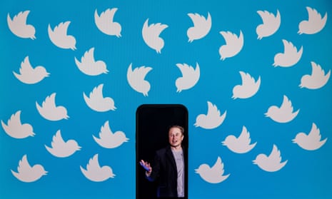 illustration shows a cellphone displaying a photo of Elon Musk placed on a computer monitor filled with Twitter logos