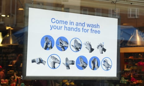 A sign in the window of a cosmetics shop in south-west London offering customers free hand washing facilities in March