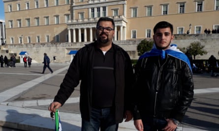 Dimitris Orfanoudakis and his son, Giorgos, outside the Greek parliament