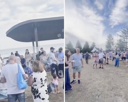 People stand in small groups in a park