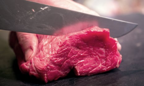 Meat being cut on a chopping board