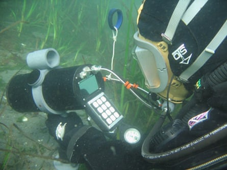 A diver with monitoring equipment on the seabed.