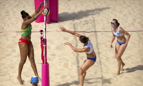 Grenada’s Renisha Stafford blocks a hit by Scotland’s Melissa Coutts as her teammate Lynne Beattie looks on during their preliminary round women’s beach volleyball match at the Coolangatta Beachfront during the 2018 Commonwealth Games.