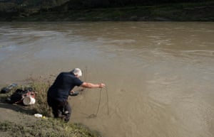 Brent Caldwell, an environmental monitoring specialist from New Zealand’s National Institute of Water and Atmospheric Research, takes readings in the lower river