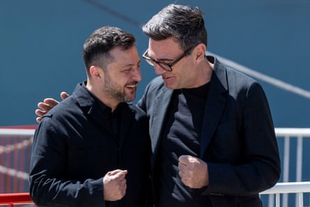 Volodymyr Zelenskyy and Andy Burnham speaking as they look as if they’re about to bump fists