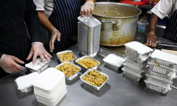 Staff at the Lahore Spice restaurant prepare meals to be donated to homeless people in Tooting, south London.