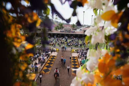 Horses and jockeys make their way from the paddock to the track at Del Mar on Breeders’ Cup weekend.