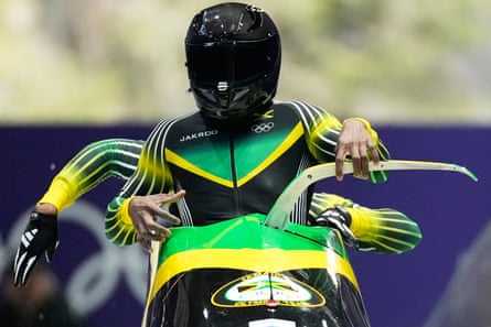 Jamaica’s two-man pair of Shane Pitter and Junior Harris get into their bobsleigh.