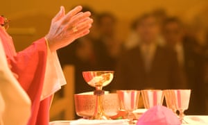 A Catholic priest celebrates holy communion.