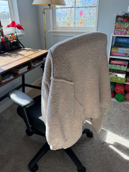 a photo of the PrettyGarden cardigan slung over an office chair by desk
