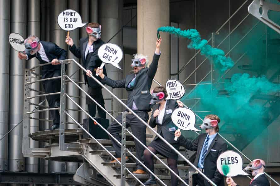 Activists gather on a stairwell at Lloyd’s of London.