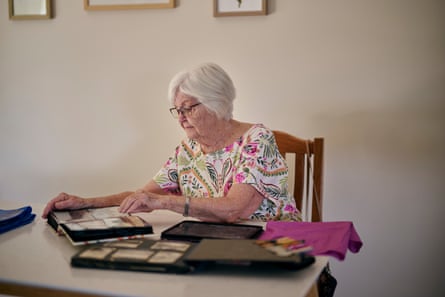 Wilma Spence at her home in Canberra, looking through photo albums