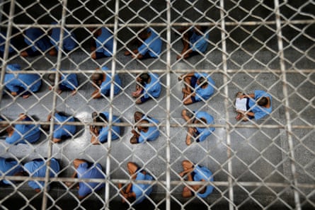 Inmates, viewed through wire from above, sit on the floor during an inspection in Klong Prem prison in Bangkok