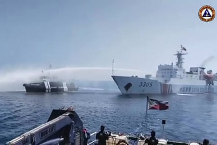 A still taken from video footage released by the Philippine Coast Guard on Saturday shows a Chinese coast guard ship using a water cannon on a Philippine fisheries vessel near Scarborough Shoal in the disputed South China Sea.