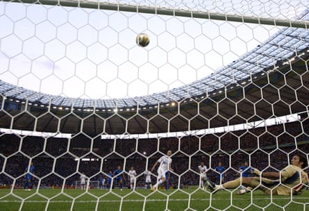 The France midfielder Zinedine Zidane, standing by the penalty spot, and the Italy goalkeeper Gianluigi Buffon, on the floor having dived to his right, watch as Zidane’s penalty goes in in the 2006 World Cup final.