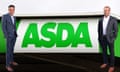 Mohsin (left) and Zuber Issa (right) pose next to a huge green and white Asda sign