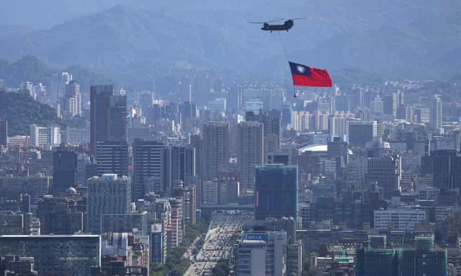 Taiwan flag is carried by a helicopter ahead of National Day celebrations in Taipei