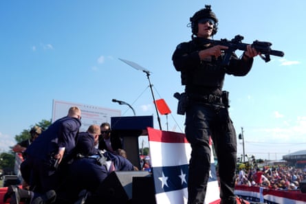 Trump is covered by Secret Service agents at a campaign rally in Butler, Pennsylvania, on 13 July.
