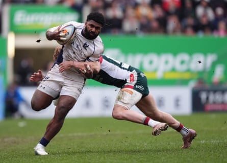 Kalaveti Ravouvou of Bristol, running with a rugby ball, tries to escape the clutches of Leicester’s Ollie Hassell-Collins.