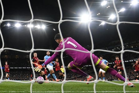 Nico O'Reilly scores Manchester City’s third goal, as seen through the net