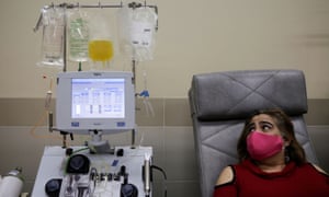 A patient in La Paz, Bolivia recovered from coronavirus is connected to a machine to separate the blood into its various components. Global cases rose by 292,000 on Friday.