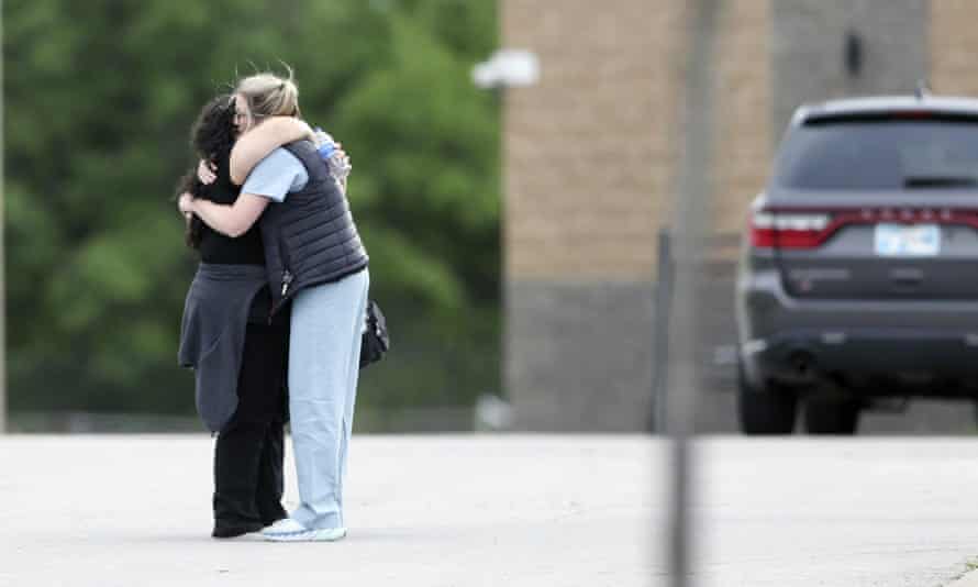 two people hug at left side of frame