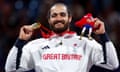 Dimitri Coutya celebrates fencing gold on the Paralympic podium.