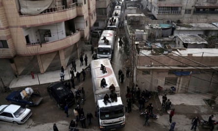 A Red Crescent convoy carrying humanitarian aid arrives in Kafr Batna, on the outskirts of the capital Damascus.