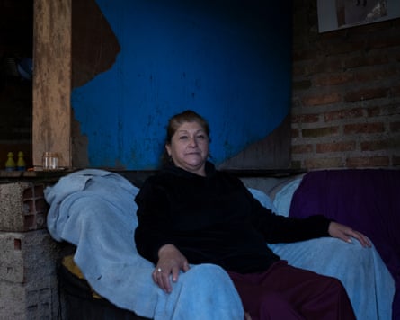 A woman siting in an armchair posing for her photograph