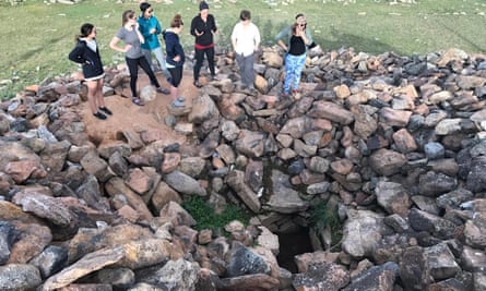 Archaeologists and Cultural Heritage Director at the American Center for Mongolian Studies, Dr. Julia Clark, shows a newly looted burial to a group of archaeology students in July, 2017.