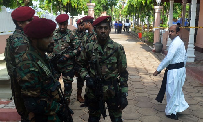 Military personnel stand guard outside St Sebastian’s Church in Negombo.