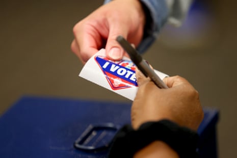A person receives an 'I Voted' sticker