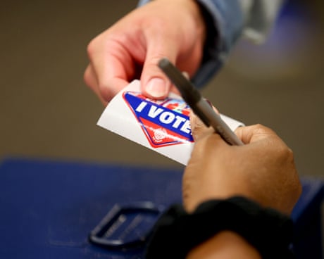 A person receives an 'I Voted' sticker
