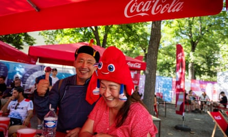 Two spectators at one of the many Coca-Cola stands that can be found at Olympic venues around the city of Paris