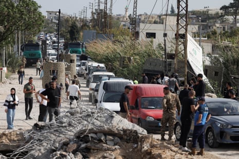 Cars line a road as they wait to cross a bridge.