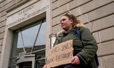 Woman holds placard