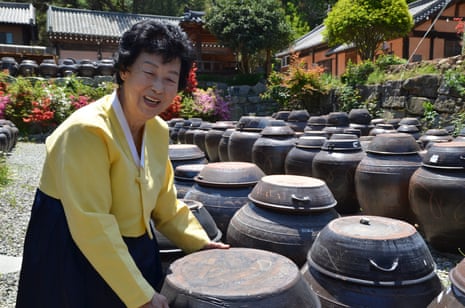 Ki Soon-do inspects one of her 1,200 prized earthenware jars. She is the only person in South Korea officially designated as a grand master of jinjang (aged soy sauce).