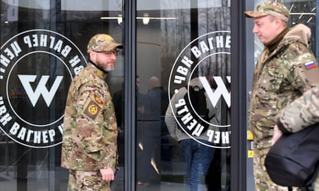 Visitors wearing military camouflage at the Wagner Centre office building in St Petersburg