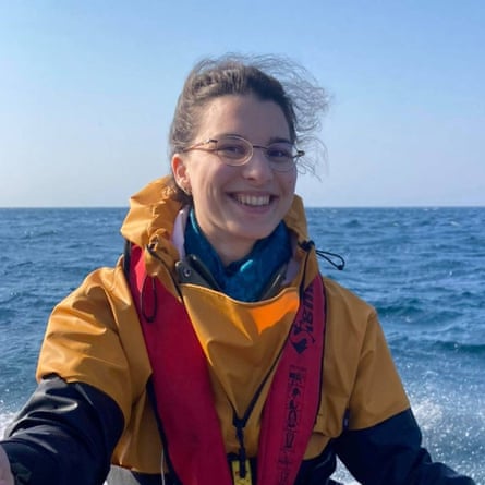 A young woman on a boat in a cagoule and lifejacket