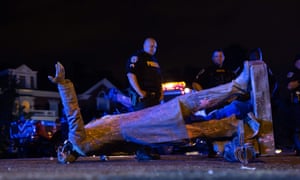 The toppled statue of Confederate States President Jefferson Davis lies on the street after protesters pulled it down in Richmond, Virginia, on 10 June.