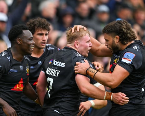 Max Norey shouts as his Chiefs teammates embrace him