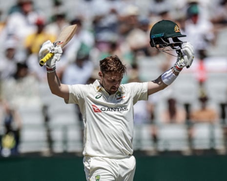 Josh Inglis raises his bat to celebrate scoring a century