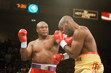 George Foreman, left, hitting Michael Moorer with a left during the second round of their heavyweight championship fight in Las Vegas, 1994.