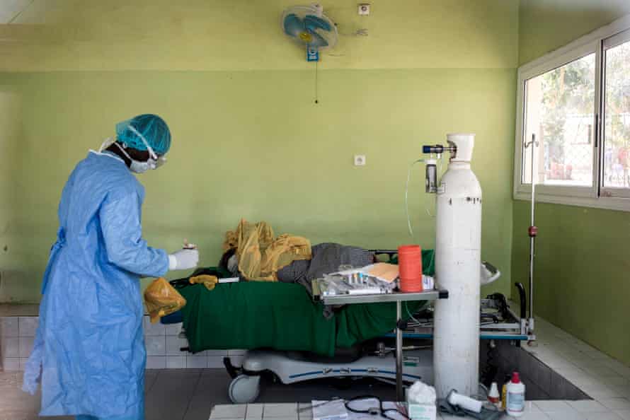 A health worker tends to a patient inside a Covid-19 ward, Pikine Hospital in Dakar, Senegal.