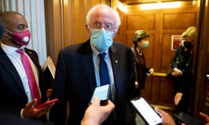 Bernie Sanders, center, talks to members of the press earlier this month on Capitol Hill.
