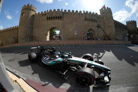 Mercedes operator George Russell of Britain drives to the grid