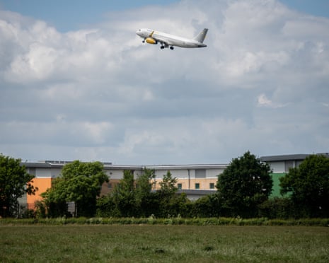 A plane takes off above Brook House Immigration Removal Centre in England.