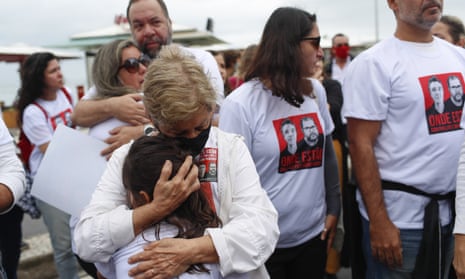 The mother-in-law of Dom Phillips embraces a girl during a protest after his disappearance.