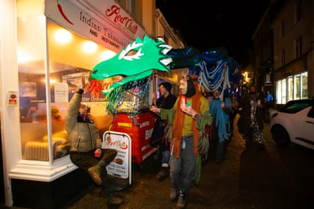 A dragon interacts with spectators on the parade route back from the recreation ground.